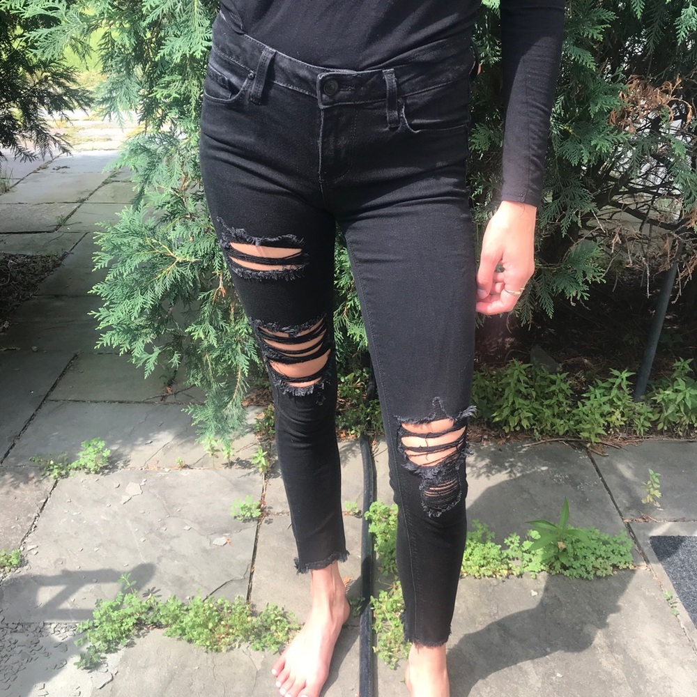 Distressed black skinny jeans